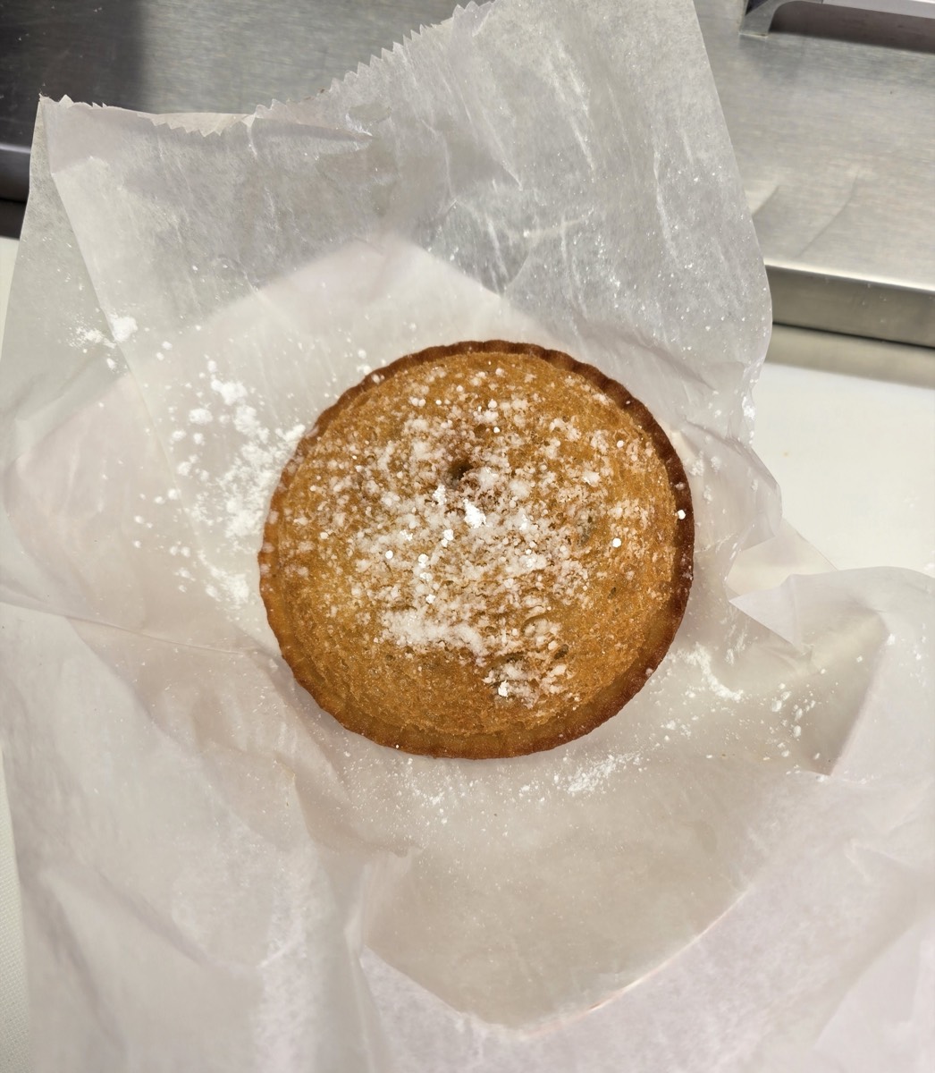 Golden deep fried peanut butter and jelly sandwich dusted with powdered sugar