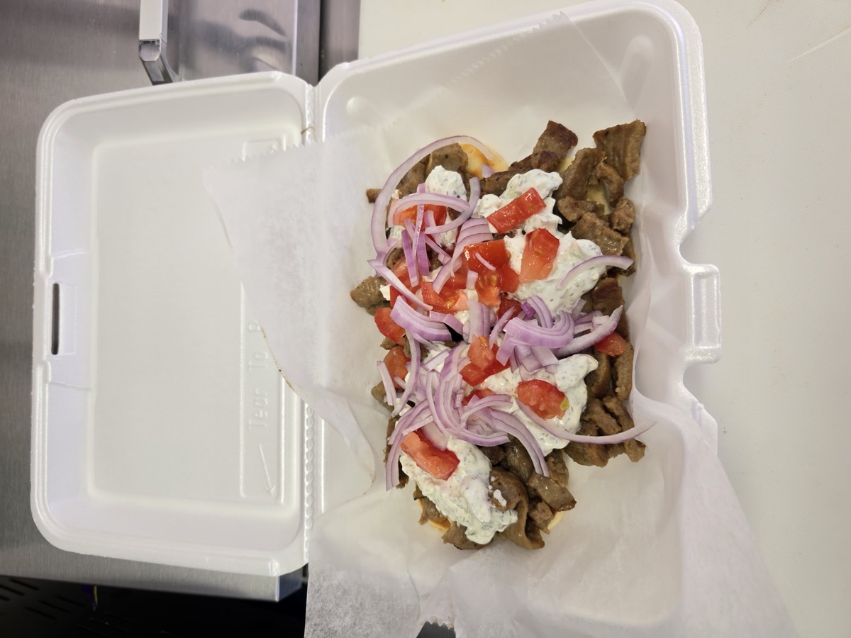 Gyro meat with tzatziki, tomatoes and red onion