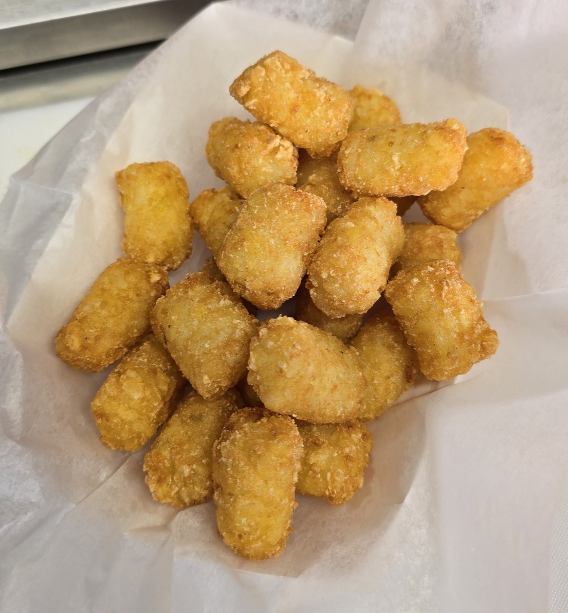 A boat of crispy golden tater tots